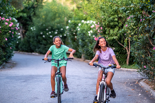 girls ride bikes and laugh