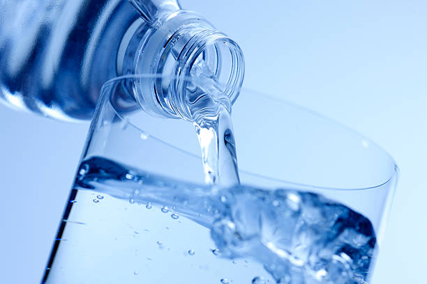 istock Water from bottle being poured into a glass 182248623