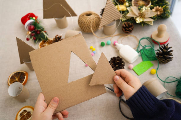 istock Step-by-step instructions on how to make a Christmas tree out of cardboard. Step 1 Cut out the triangle. Zero waste concept. 1822487001