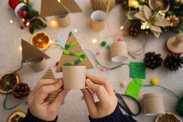 istock Step-by-step instructions on how to make a Christmas tree out of cardboard. Step 3 Decorate the Christmas tree with colorful balloons. Zero waste concept. 1822487007