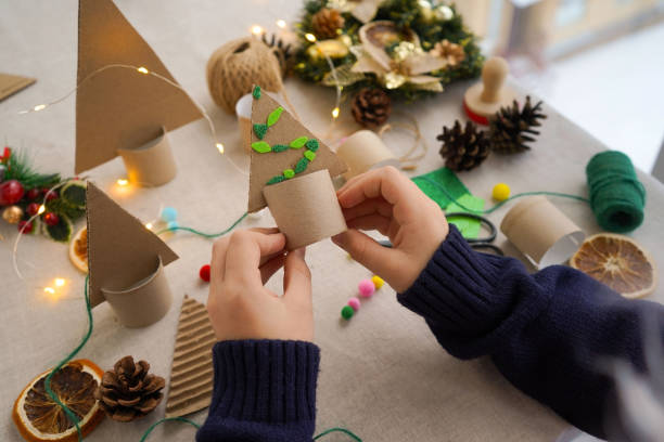 istock Step-by-step instructions on how to make a Christmas tree out of cardboard. Step 3 Decorate the Christmas tree with colorful balloons. Zero waste concept. 1822487017