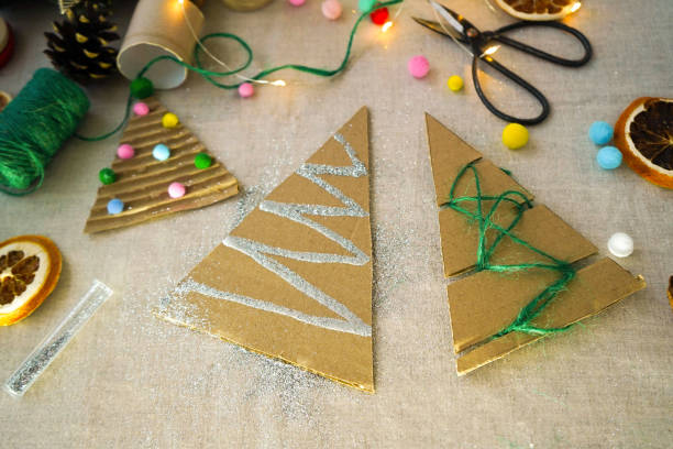 istock A creative handmade little Christmas tree of cardboard. eco-friendly and zero waste concept 1822489185