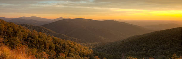 Blue Ridge Mountains at Dusk As the sun sets, a brilliant orange and yellow sky lights the Blue Ridge Mountains as nighttime approaches.  Photo was taken on the Skyline Drive in Shenandoah National Park. shenandoah national park photos stock pictures, royalty-free photos & images