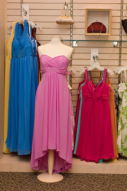 Formal Dresses Many formal dresses in various styles and colors in a dress shop. red evening gown mannequin indoors stock pictures, royalty-free photos & images