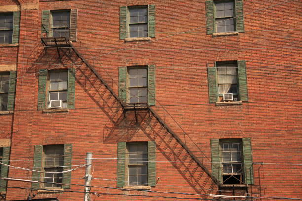 red brick wall house facade with a fire escape
