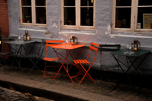 orange coffee table and chairs in front of a house