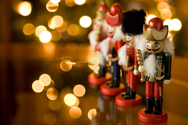 Christmas nutcracker soldiers on a mantle Nutcrackers on a glass table with out of focus christmas lights in the background. nutcracker photos stock pictures, royalty-free photos & images