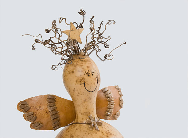 Three small pumpkins with painted faces on white background.
