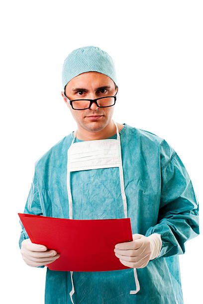 istock Male Surgeon Standing with Medical Chart, Studio Portrait 182251140