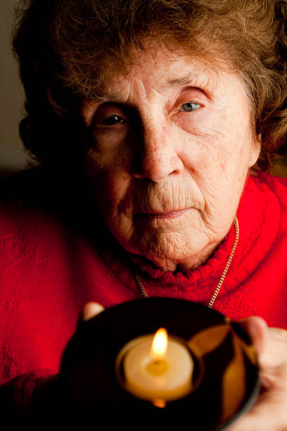 istock Elderly Woman Holding Candle 182251405