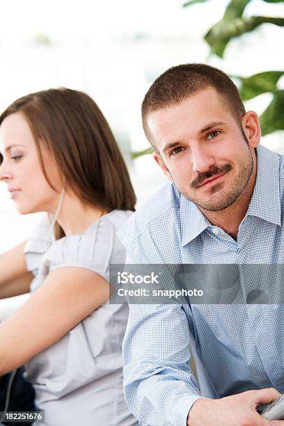 Attractive Couple Sitting Together At Home Stock Photo - Download Image Now - 25-29 Years, 30-34 Years, Adult