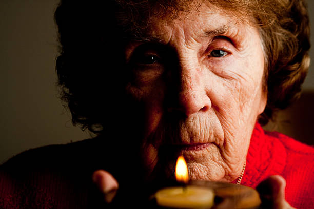 istock Elderly Woman Holding Candle 182251860