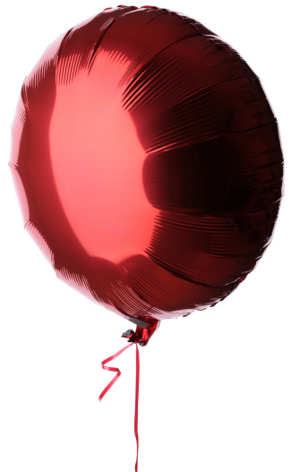 A round red foil balloon with a matching red ribbon.Isolated against a white background.