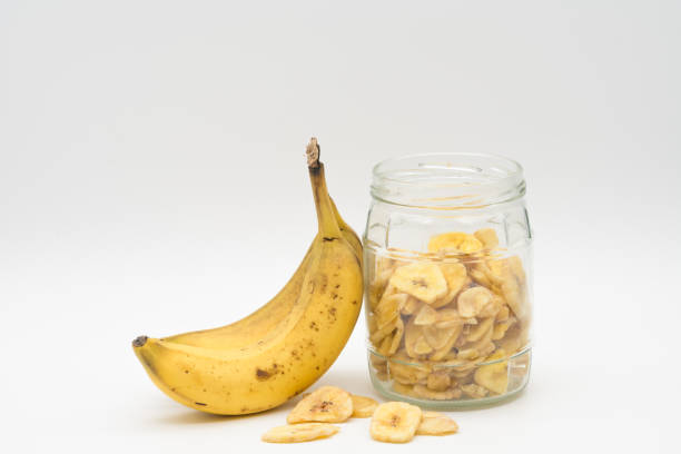 istock Banana chips in glass jar isolated on white backround 1822527602