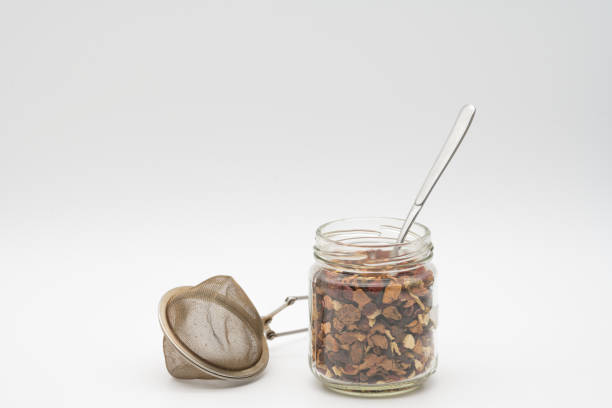 Organic tea in glass jar isolated on white background for a zero waste lifestyle. Environmentally friendly shopping in a plastic-free grocery store.