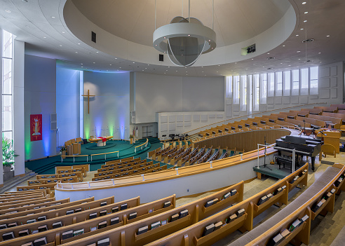 Details of the interior of a modern Catholic church in light colors.