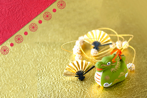 Japanese New Year of the  Dragon, Zodiac symbol of the year on gold   washi background  with    temari garland and gold fan.