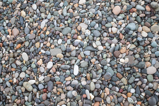 Texture of diverse sea pebbles. Stone beach.