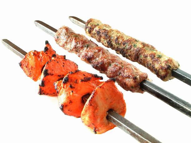 istock tikka kofta and shish kebab on skewers against white background 182256039