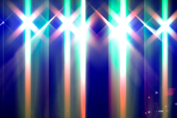 istock Bright festive multi-colored stage lighting with optical flare and rays from lighting lamps. 1822563109