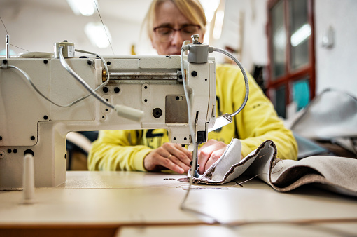 Seamstress works in furniture factory