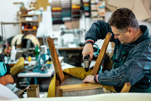 istock Technician works with staple gun in furniture workshop 1822572957