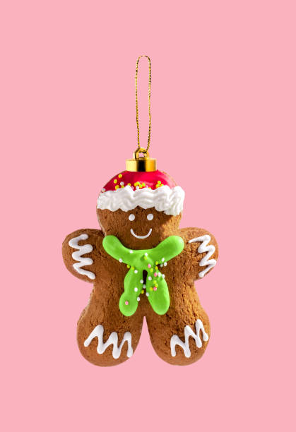 Gingerman cookie Christmas tree toy on  pink background. Creative collage.