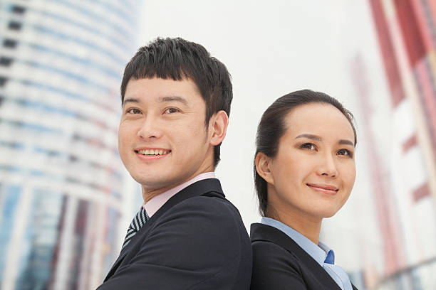 istock Young business man and woman standing 182259010