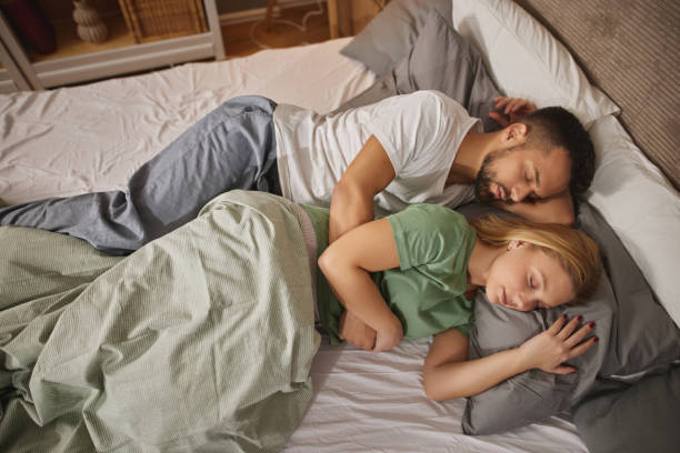 istock Couple sleeping embraced in bed 1822591707