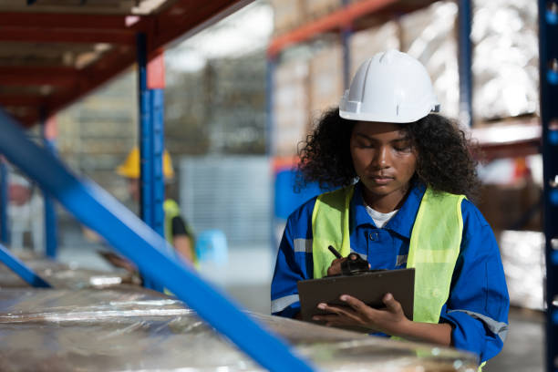 istock Warehouse and storage concept. African American female warehouse worker checking barcodes on boxes on shelf pallet in the storage warehouse. Woman worker working in the warehouse 1822594511
