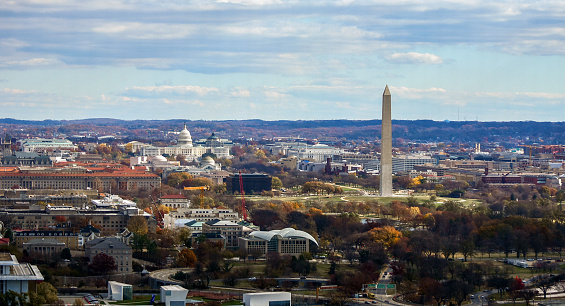 Washington DC skyline and monumnets seen from an observation deck in Arlington, Virginia. U.S. Capitol dome is at left, tall Washington Monument is at right.