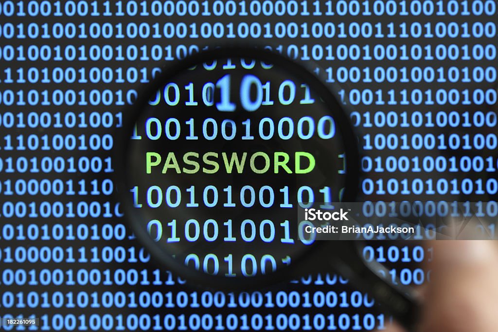 Password security Internet security concept hacker reading the word password on a digital tablet screen with a magnifying glass Computer Crime Stock Photo