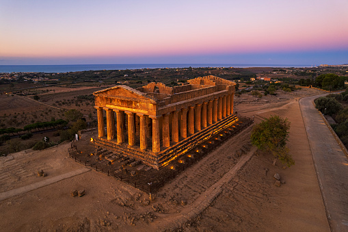 The greek temple of Concordia illuminated at dawn, aerial view, Agrigento valley of temples, UNESCO world heritage site, Agrigento province, Sicily, Italy, Europe