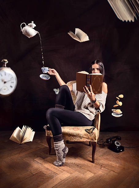 istock Woman reading book with abstract flying items around her 182264533