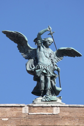 One of the Bernini Angels on the Ponte Sant' Angelo against a blue sky in Rome, Italycirca the 16th century.