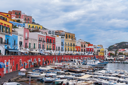 View of the colorful houses of the traditional italian fishing village of Ponza with the busy touristic marina full of small boats, Ponza island, Pontine archipelago, Tyrrhenian sea, Latina province, Latium, Italy, Europe