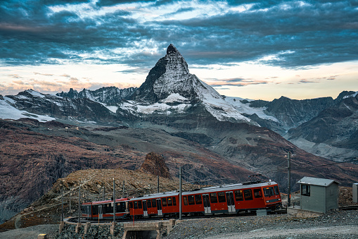 Electric train running on railway through Matterhorn iconic mountain in Gornergrat station, Zermatt, Switzerland