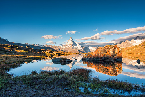 Beautiful landscape of Lake Stellisee with Matterhorn iconic mountain, Swiss alps and stones reflection in the morning at Zermatt, Switzerland