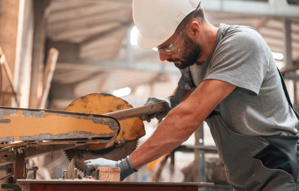istock Sitting and working. Young man at the factory in grey uniform 1822657255