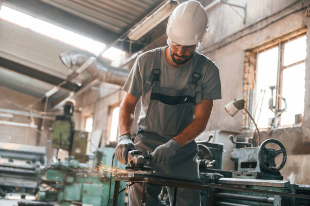 istock Busy day. Young factory worker in grey uniform 1822657266