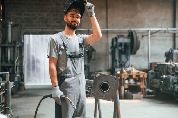 istock Taking a break. With welding equipment. Young factory worker in grey uniform 1822658149