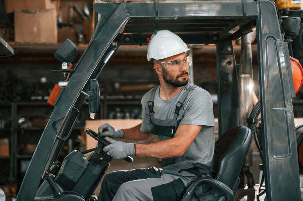istock Driving the forklift. Young factory worker in grey uniform 1822658895