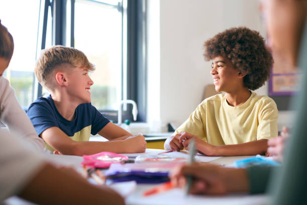 istock Two Male Secondary Or High School Students Sitting At Table In Science Class Working Together 1822659046