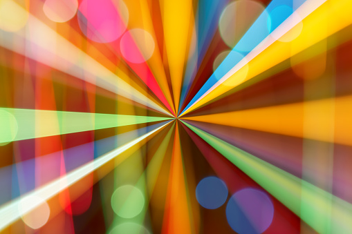 Abstract multi colored light beams background with bokeh.