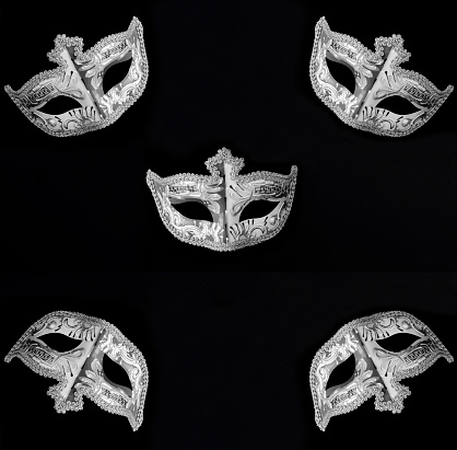 Venetian carnival masks on the black background. Top view. Flat lay. Close-up.