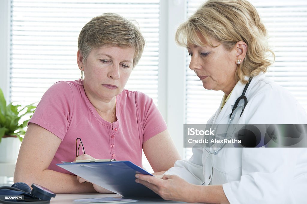 Doctor and patient physician discusses test results with her female patient at the doctor's office Medical Test Stock Photo