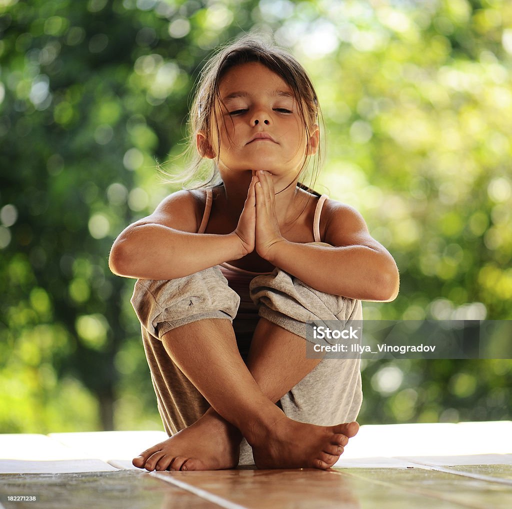 girl on meditation in the morning park Child Stock Photo