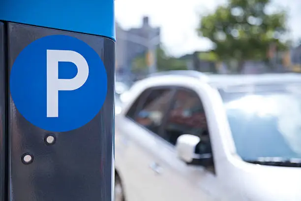 Photo of A blue parking ticket machine beside the road 