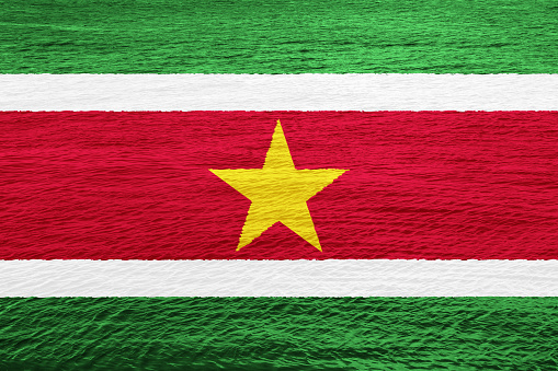 Flag of Republic of Suriname on a textured background. Concept collage.