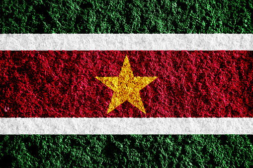 Flag of Republic of Suriname on a textured background. Concept collage.